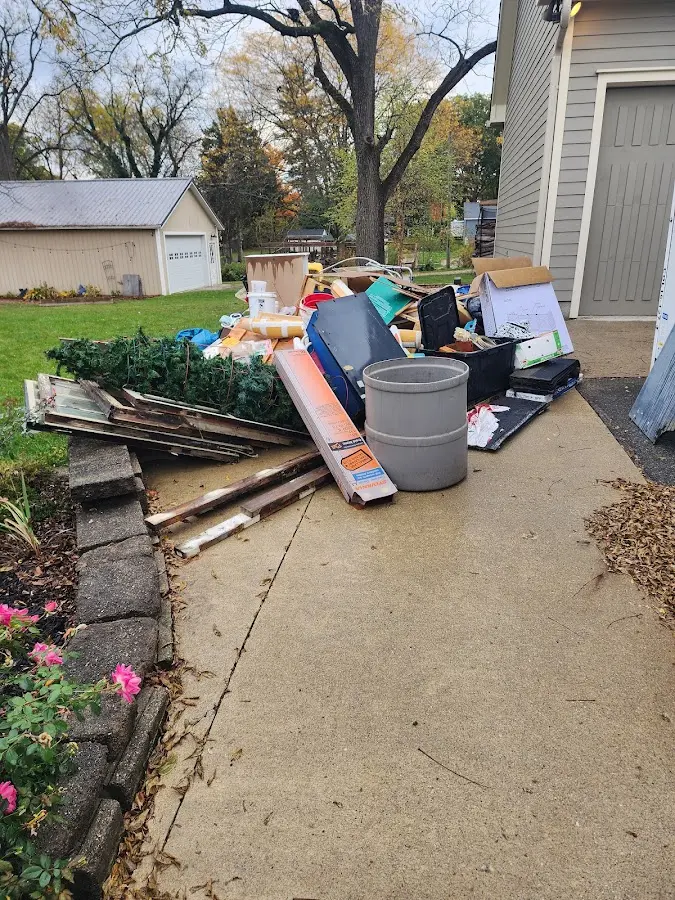 Dumpster being loaded with debris for Roofing Dumpster Rental in Windham